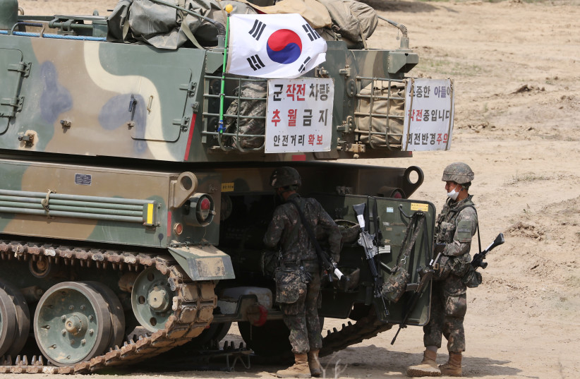  South Korean soldiers work on their self-propelled artillery vehicles during a military exercise near the demilitarised zone separating the two Koreas in Yangju, South Korea, May 25, 2022 (photo credit: KIM HONG-JI/ REUTERS)