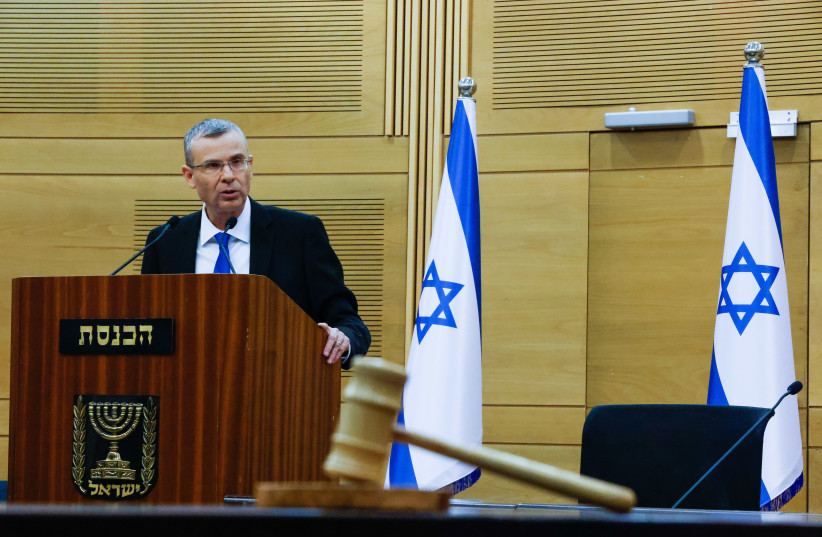  Israel's Justice Minister Yariv Levin allegedly blinks for help while pretending to look at a gavel ( PURIM SHPIEL PARODY ILLUSTRATIVE).  (credit: OLIVIER FITOUSSI/FLASH90)