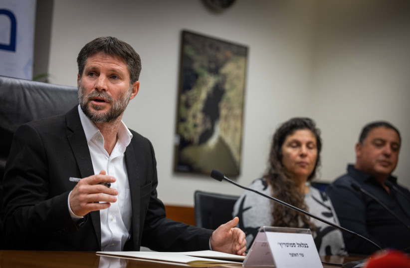  Finance Minister Bezalel Smotrich holds a press conference with bereaved families at the Israeli Finance Ministry in Jerusalem on January 8, 2023. (credit: YONATAN SINDEL/FLASH90)