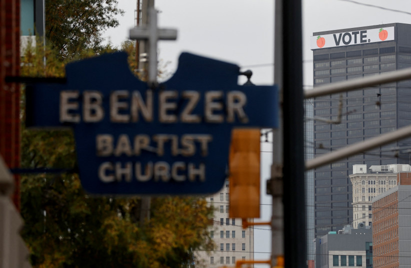 A ''Vote'' sign tops the 100 Peachtree building seen looking past historic Ebenezer Baptist Church, where U.S. Senator Raphael Warnock (D-GA) is the current pastor, just days ahead of nationally significant U.S. Senate and state governor elections in Atlanta, Georgia, US November 6, 2022. (credit: JONATHAN ERNST/REUTERS)