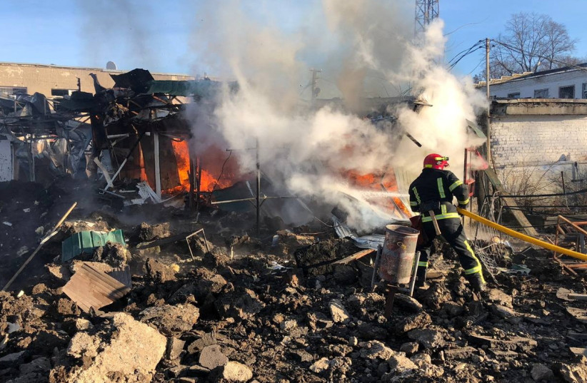  Firefighter works at a site of a market hit by Russian missiles in the town of Shevchenkove (photo credit: REUTERS)
