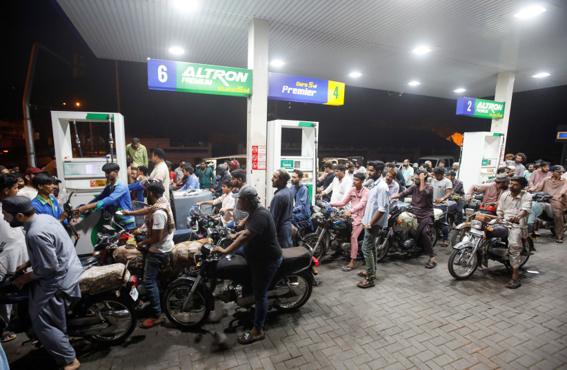 People wait their turn to get fuel at a petrol station, in Karachi, Pakistan, June 2, 2022. (photo credit: REUTERS/AKHTAR SOOMRO)
