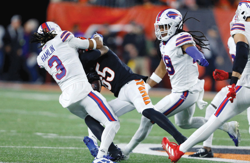  BUFFALO BILLS safety Damar Hamlin (3) makes the tackle on Cincinnati Bengals wide receiver Tee Higgins after which Hamlin collapsed on the field and was taken to the hospital in critical condition, in Cincinnati, last week.  (photo credit: Joseph Maiorana-USA TODAY Sports/Reuters)