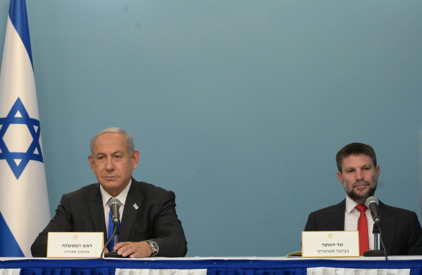  Prime Minister Benjamin Netanyahu and FInance Minister Bezalel Smotrich present the government's financial plan on January 11, 2023 (photo credit: AMOS BEN-GERSHOM/GPO)