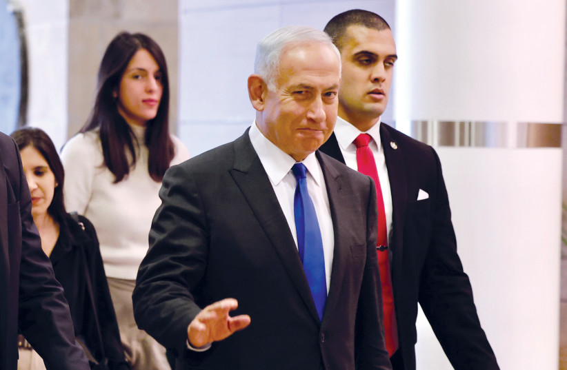  Netanyahu enters the Knesset on December 29 for the presentation of his new government. (credit: MARC ISRAEL SELLEM)