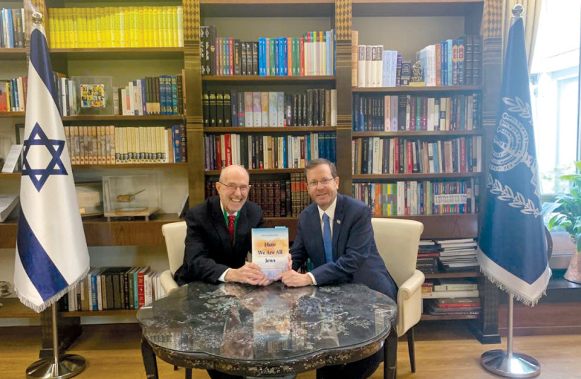  Jonathan Porath presents his book to President Isaac Herzog. (photo credit: PRESIDENT'S OFFICE)