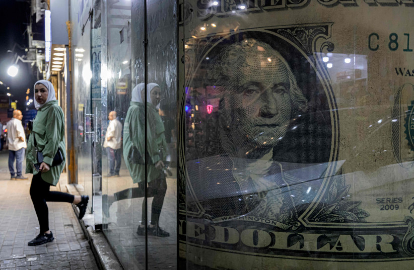  EXITING A currency exchange shop in Cairo. (photo credit: Khaled Desouki/AFP via Getty Images)