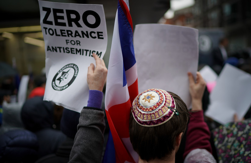   Campaigners from the Campaign Against Antisemitism demonstrate and listen to speakers outside the Labour Party headquarters on April 8, 2018 in London, England.  (photo credit: Christopher Furlong/Getty Images)
