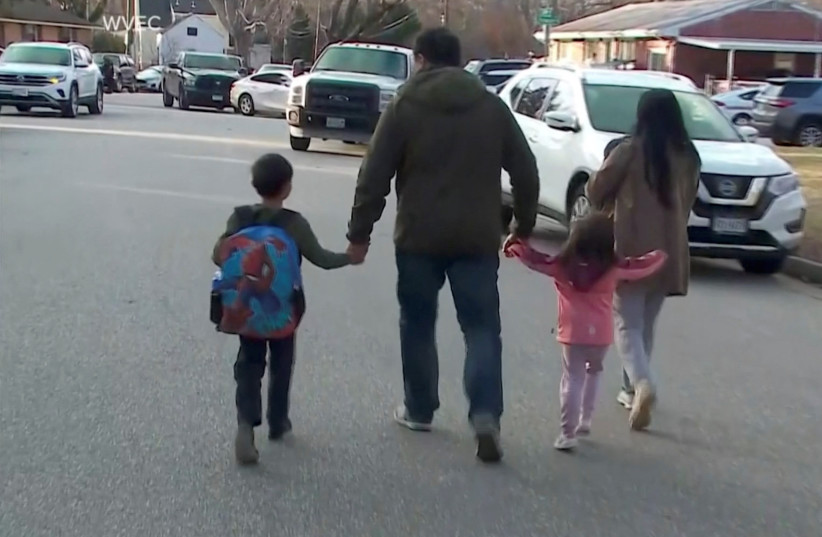  Parents walk with children outside Richneck Elementary School, where according to the police, a six-year-old boy shot and wounded a teacher, in Newport News, Virginia, U.S., January 6, 2023 (credit: WVEC VIA ABC/HANDOUT VIA REUTERS)
