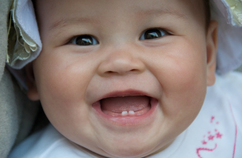  Baby with two baby teeth. (photo credit: FLICKR)