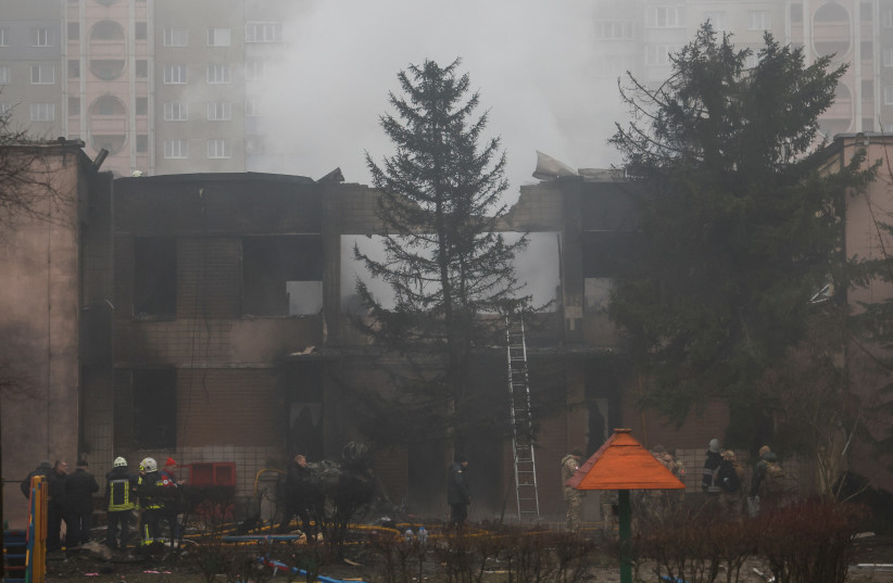  A view shows the site a where a helicopter falls on civil infrastructure buildings, amid Russia's attack on Ukraine, in the town of Brovary, outside Kyiv, Ukraine, January 18, 2023.  (photo credit: REUTERS/VALENTYN OGIRENKO)