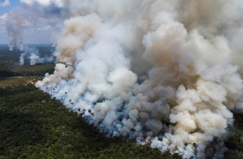  Smoke from burning vegetation rises in Brazilian Amazon rainforest near the Transamazonica national highway, in Humaita, Amazonas state, Brazil, September 8, 2021.  (credit: REUTERS/BRUNO KELLY)