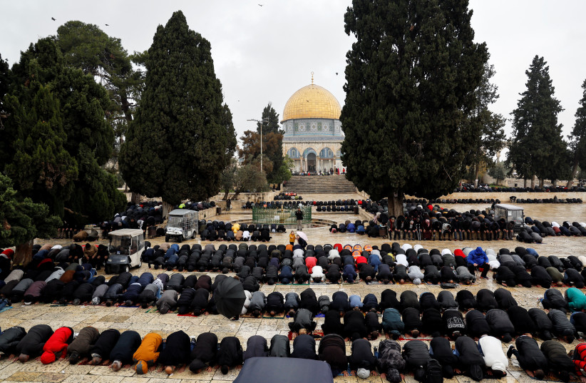  Muslims pray on the compound known to Muslims as Noble Sanctuary and Jews as Temple Mount, in Jerusalem's Old City January 6, 2023. (photo credit: REUTERS/AMMAR AWAD)