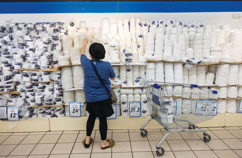  A WOMAN shops for disposable plastic tableware at an Osher Ad Supermarket branch in the Givat Shaul neighborhood of Jerusalem. (photo credit: YONATAN SINDEL/FLASH90)