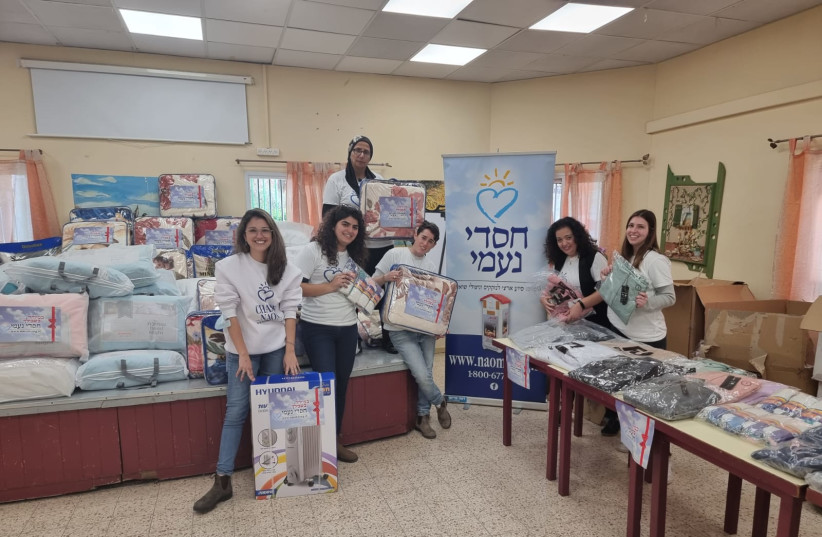   Volunteers at the Chasdei Naomi charity organization prepare blankets and heaters to help needy Israelis get through the winter. (credit: chasdei naomi)