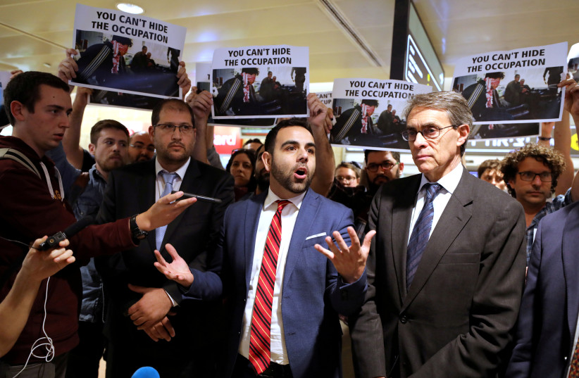  Omar Shakir, a U.S. citizen representing New York-based Human Rights Watch (HRW) in Israel and the Palestinian territories, stands next to Kenneth Roth executive director of HRW, while speaking before departing Israel at Ben Gurion International Airport, near Tel Aviv, Israel November 25, 2019. (credit: AMMAR AWAD/REUTERS)