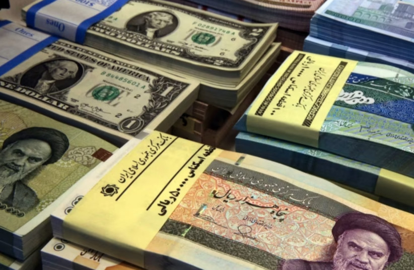 Iran's national currency along with US currency. (photo credit: Wikimedia Commons)