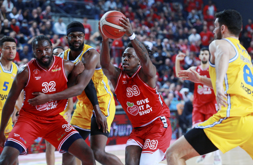  HAPOEL TEL AVIV guard J’Covan Brown (with ball) scored a game-high 32 points to lead the Reds to a narrow 96-95 victory over city rival Maccabi Tel Avi on Sunday. (photo credit: Kobi Eliyahu)