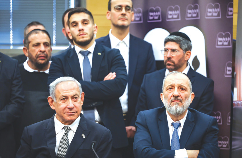 PRIME MINISTER Benjamin Netanyahu sits alongside sacked cabinet minister Arye Deri in the Knesset, on Monday. In Israel, the coalition controls the legislature and executive, thus the need to keep its hands off judicial appointments, says the writer.  (photo credit: YONATAN SINDEL/FLASH90)