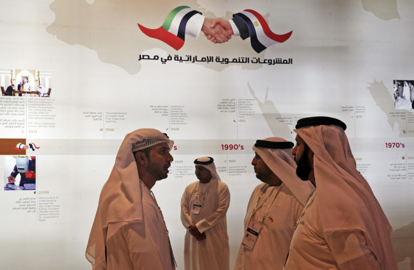  Emirati investors interact in front of a sign reading ''Development projects in Egypt'', at the opening of the Egypt Economic Development Conference (EEDC) in Sharm el-Sheikh, in the South Sinai governorate (credit: Amr Abdallah Dalsh/Reuters)