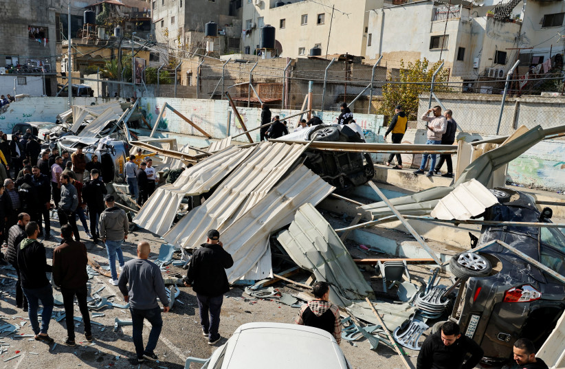  Palestinians inspect the damage following an Israeli raid in Jenin in the West Bank January 26, 2023.  (credit: REUTERS/RANEEN SAWAFTA)