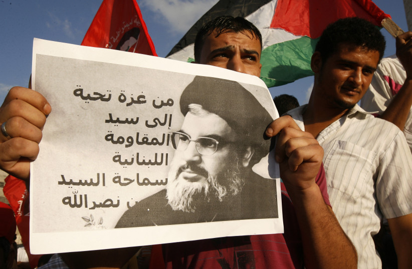  PROTESTING IN the Gaza Strip with a picture of Hezbollah head Hassan Nasrallah.  (credit: ABED RAHIM KHATIB/FLASH90)