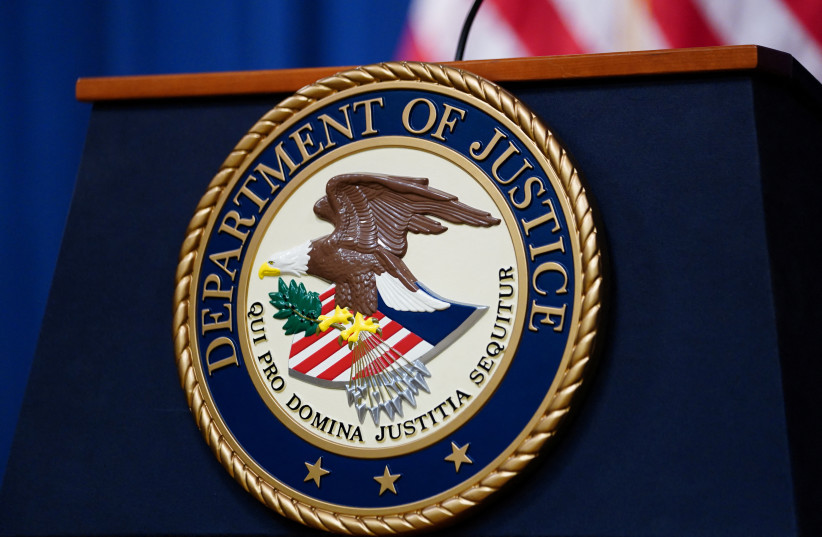  The seal of the US Justice Department is seen on the podium in the Department's headquarters briefing room before a news conference with the Attorney General in Washington, January 24, 2023. (photo credit: REUTERS/KEVIN LAMARQUE)