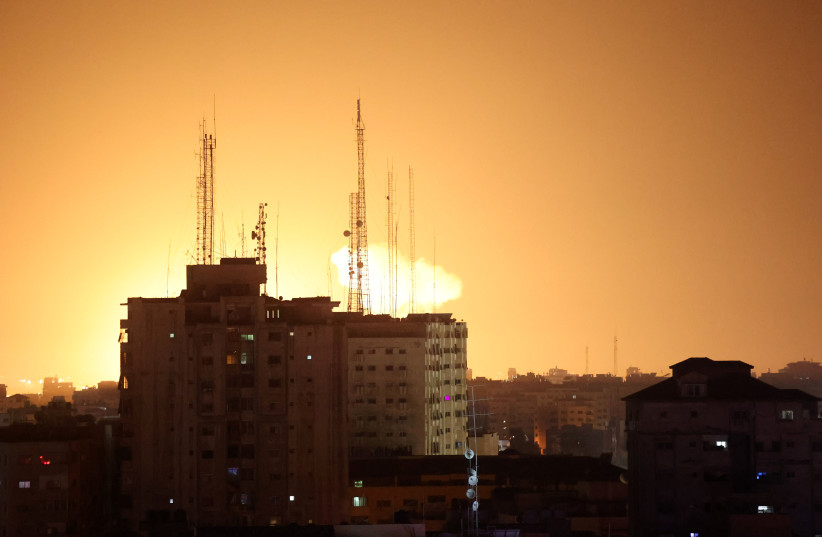  A ball of fire and smoke rises during Israeli airstrikes in the Gaza Strip, early on on January 27, 2023 (photo credit: ATTIA MUHAMMED/FLASH90)