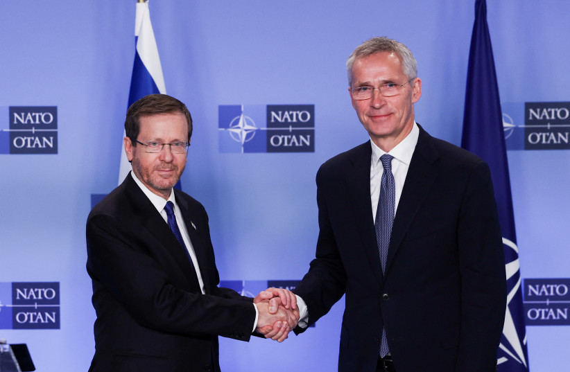  NATO Secretary General Jens Stoltenberg shakes hands with Israeli President Isaac Herzog at the Alliance's headquarters in Brussels, Belgium January 26, 2023 (credit: YVES HERMAN/REUTERS)