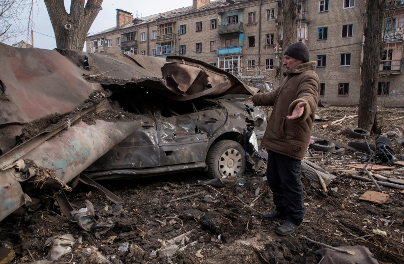  Local resident Serhii stands next to his car destroyed by a Russian missile strike, amid Russia's attack on Ukraine, in Kostiantynivka, Donetsk region (photo credit: REUTERS)