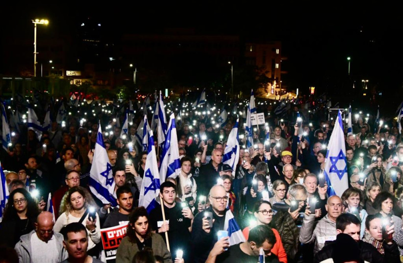 Protesters in Tel Aviv observe a minute of silence for the victims of the deadly Jerusalem terror attack on Friday night, January 28, 2022. (photo credit: AVSHALOM SASSONI/MAARIV)