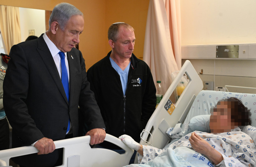  Prime Minister Benjamin Netanyahu seen visiting Israelis injured in terror attacks across Jerusalem on January 29, 2023 (credit: HAIM ZACH/GPO)