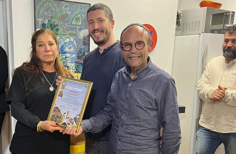  Aharon Granot, founder of Osey Chail and the organization's CEO Aaron Kurtz pose for a picture with Dalia Falah, mother of the late Maj. Bar Falah, at the dedication of ''Bar's House'' home for lone soldiers in Lod.  (credit: COURTESY OF OSEY CHAIL)