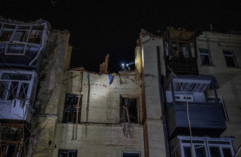  A rescuer works at the site where an apartment building was heavily damaged by a Russian missile strike, amid Russia's attack on Ukraine, in Kharkiv, Ukraine January 30, 2023.  (photo credit: REUTERS/YEVHEN TITOV)