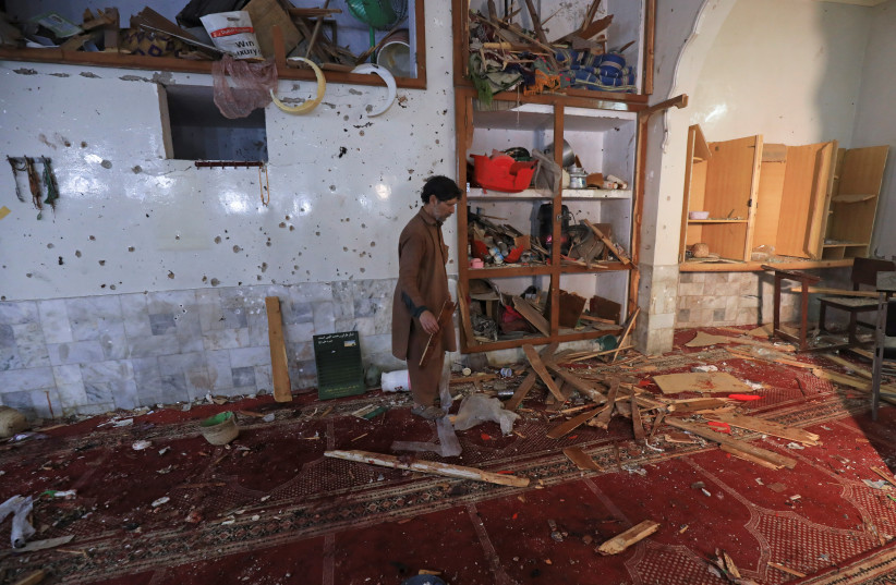  A man walks amid the damages at the prayer hall after a bomb blast inside a mosque during Friday prayers in Peshawar, Pakistan, March 4, 2022. (credit: REUTERS/FAYAZ AZIZ)