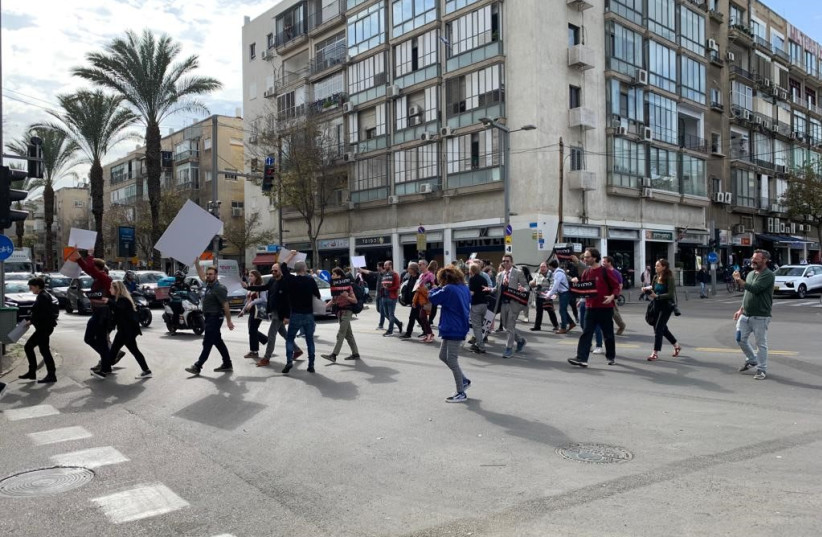 Members of the Israeli media protest at a busy intersection in downtown Tel Aviv over the govenrment's plans to cut funding to the national public broadcaster, Jan. 29, 2023. (photo credit: THE MEDIA LINE)
