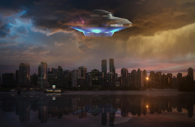  An alien UFO is seen above a city in this illustrative image. (credit: PIXABAY)