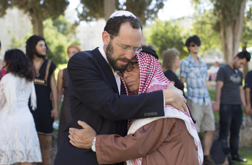  RABBI DR. YAKOV NAGEN: Simply loves people. Pictured: Embracing Haj Ibrahim Ahmad Abu el-Hawa, clan chief whose family has been residing in the Jerusalem area for many generations.  (photo credit: Sarah Schuman/Flash90)