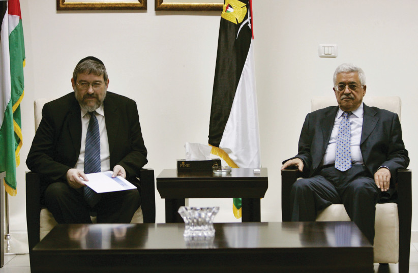  PALESTINIAN AUTHORITY President Mahmoud Abbas (R) meets with Labor Party lawmaker Rabbi Michael Melchior in Ramallah, 2006.  (photo credit: Loay Abu Haykel/Reuters)