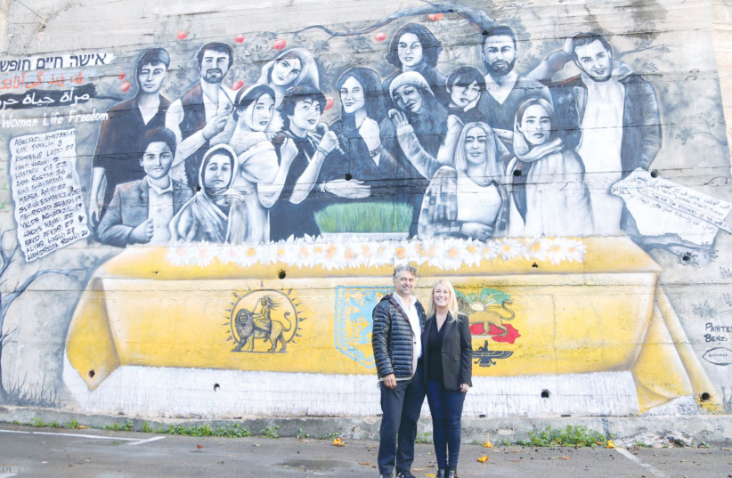  HOOMAN KHALILI (left) and the writer stand in front of the mural.  (photo credit: Shadi Obied)