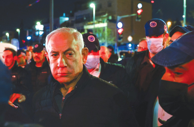  PRIME MINISTER Benjamin Netanyahu observes the scene of last Friday’s terrorist attack at Jerusalem’s Neve Yaakov neighborhood. (photo credit: RONEN ZVULUN/REUTERS)