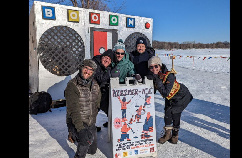 From left to right: klezmer musicians Greg Schweser, Pat O'Keefe, Josh Rosard, Michael Leville, and Sarah Larsson pose for a picture in front of the Art Shanty popup in Minneapolis. (photo credit: COURTESY OF JOSH ROSARD)