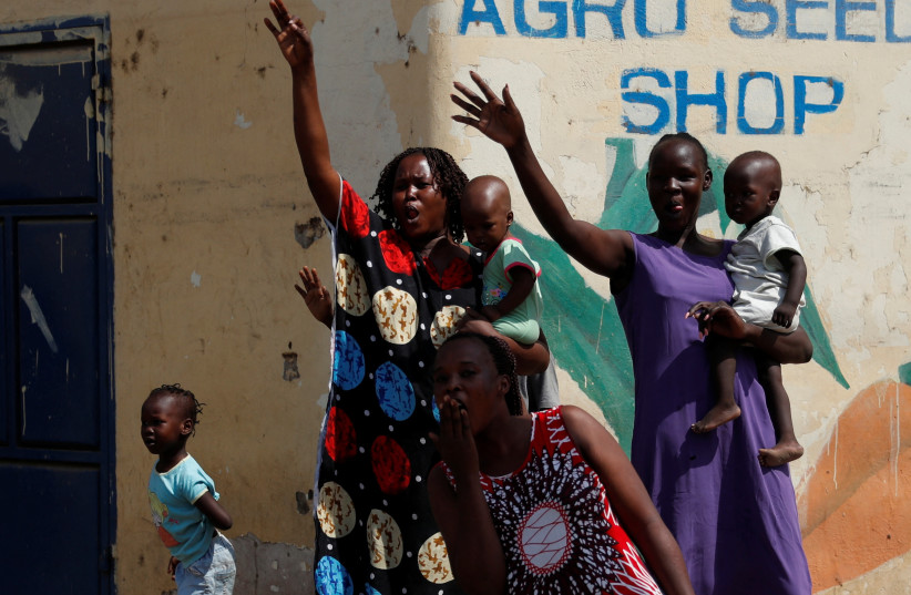  Women and children react in the street on the second day of Pope Francis' apostolic journey in Juba (credit: REUTERS)
