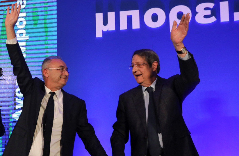  Cyprus' President Nicos Anastasiades and Cyprus presidential candidate Averof Neophytou, head of the governing right-wing Democratic Rally party, waves to supporters during a pre-election rally in Nicosia (credit: REUTERS)