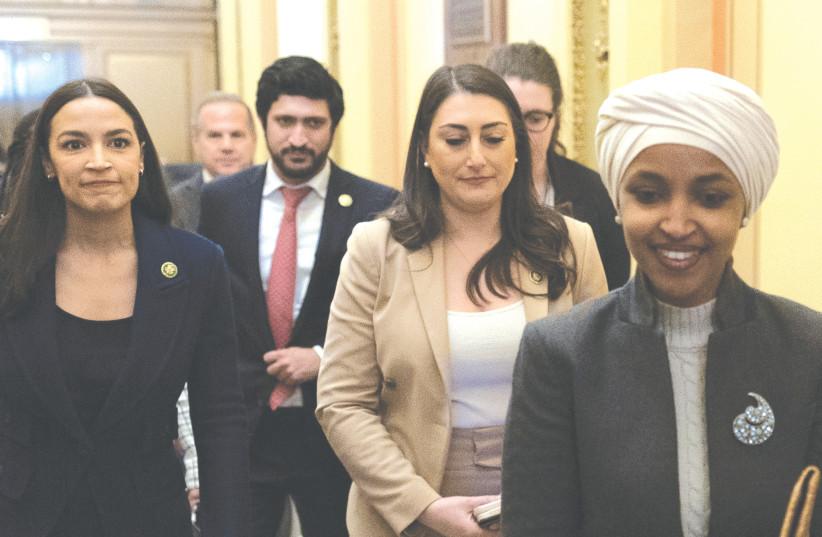  US REP. Ilhan Omar (right) walks through the corridors of Capitol Hill after her removal from the House Foreign Affairs Committee last week, as fellow ‘Squad’ member Rep. Alexandria Ocasio-Cortez (left) looks on. (photo credit: TOM BRENNER/REUTERS)