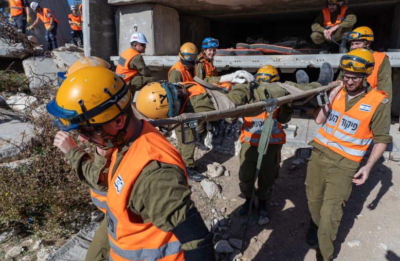  Members of the Knesset Honor Guard, Home Front Command, Firefighters, IDF and Israel's Magen David Adom Emergency Medical Services participate in an emergency drill simulating an earthquake near Ashkelon,  on December 19, 2019. (credit: YANIV NADAV/FLASH90)