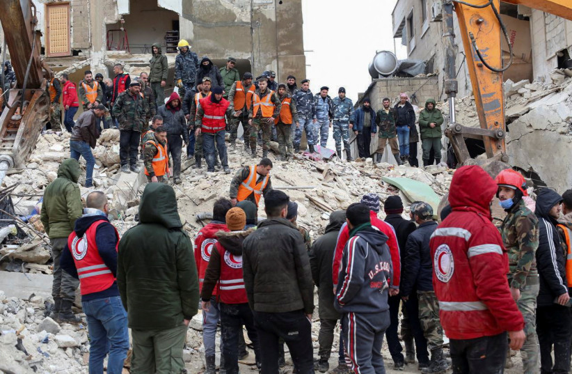 Rescuers search for survivors at the site of a collapsed building, following an earthquake, in Hama, Syria February 6, 2023.  (photo credit: REUTERS/YAMAM AL SHAAR)