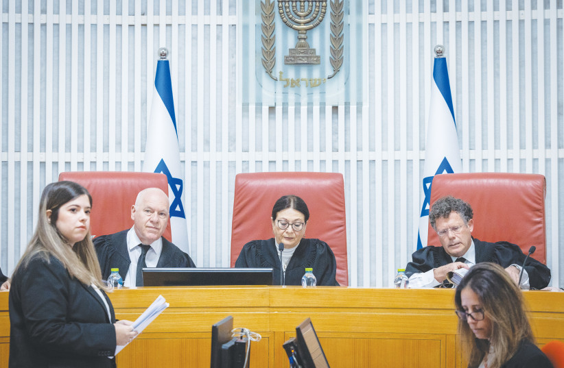  SUPREME COURT President Esther Hayut flanked by justices Uzi Vogelman (left) and Isaac Amit. The court has, in fact, not dared to decisively impact the burning issues rending Israeli society, says the writer.  (photo credit: YONATAN SINDEL/FLASH90)