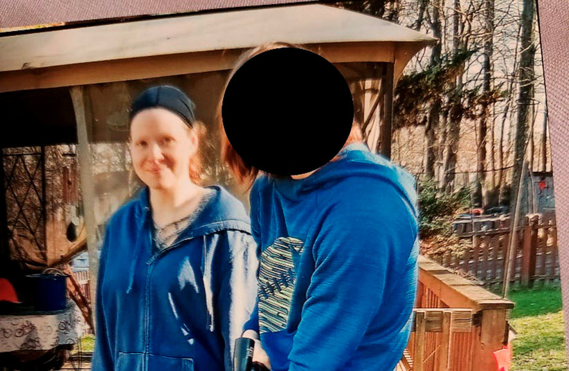  A woman believed to be suspect Sarah Clendaniel stands with what appears to be a minor holding a rifle, in this undated image, released by the US Department of Justice on February 6, 2023, after the FBI arrested alleged neo-Nazi leader Brandon Russell and Clendaniel. (credit: FBI/US Department of Justice/Handout via REUTERS, US Attorney's Office for the District of Maryland/Handout via REUTERS)