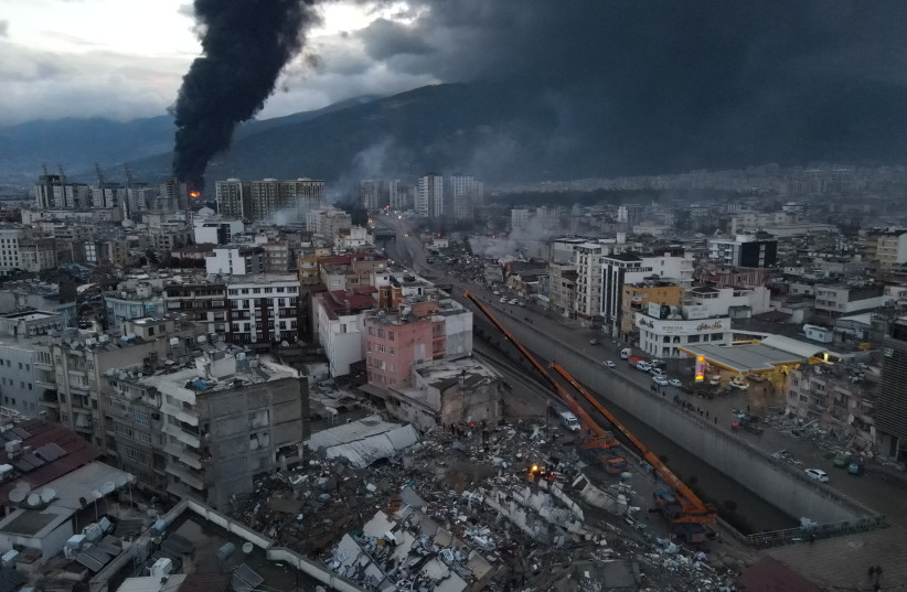  Black smoke from a fire rises over central Iskenderun, following an earthquake in Turkey February 7, 2023. (photo credit: Serday Ozsoy/Depo Photos via REUTERS)